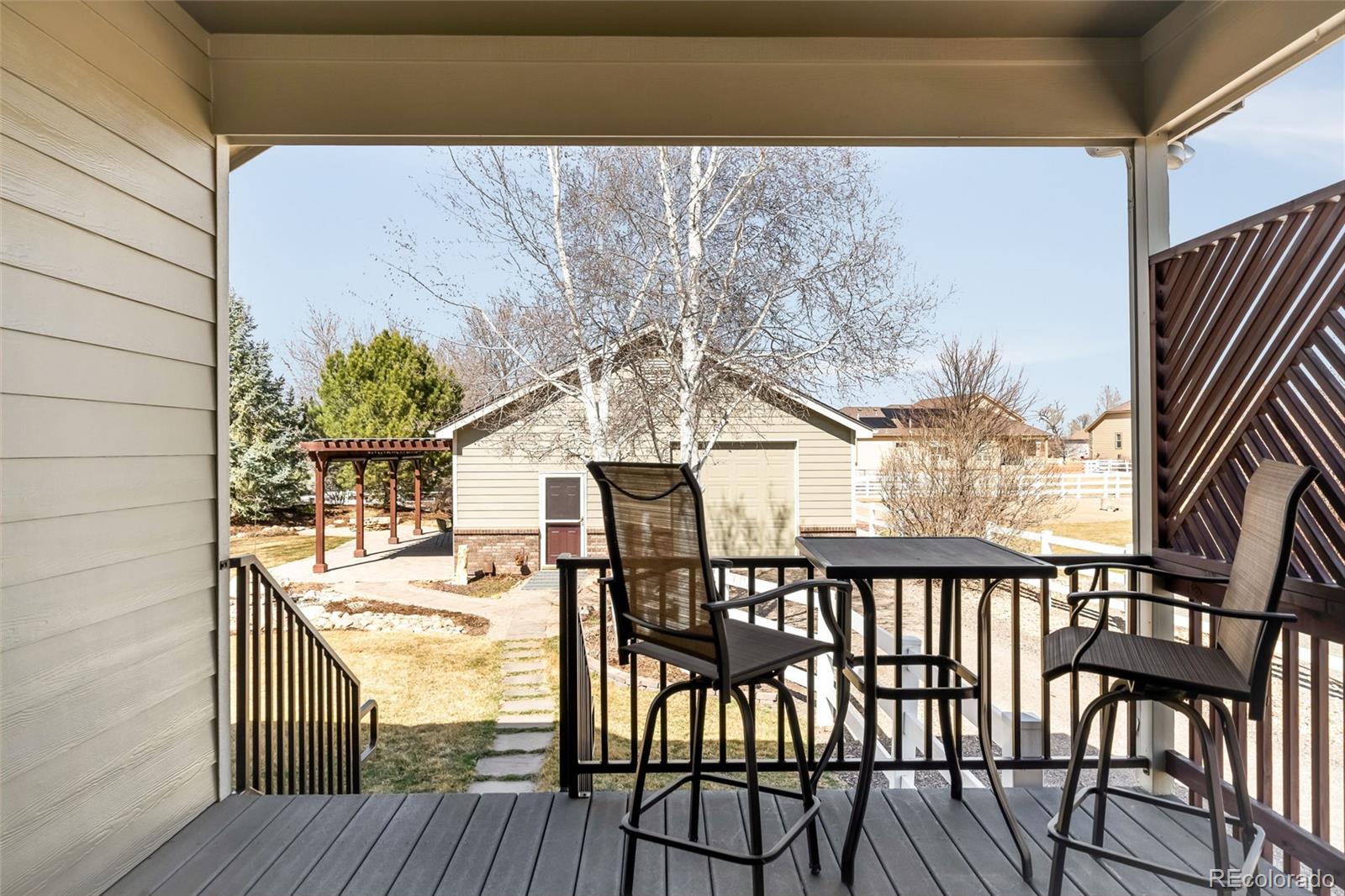 2013 Trail Ridge Drive Severance, CO 80615 - Photo 39 of 49 a view of a balcony with wooden floor and iron fence