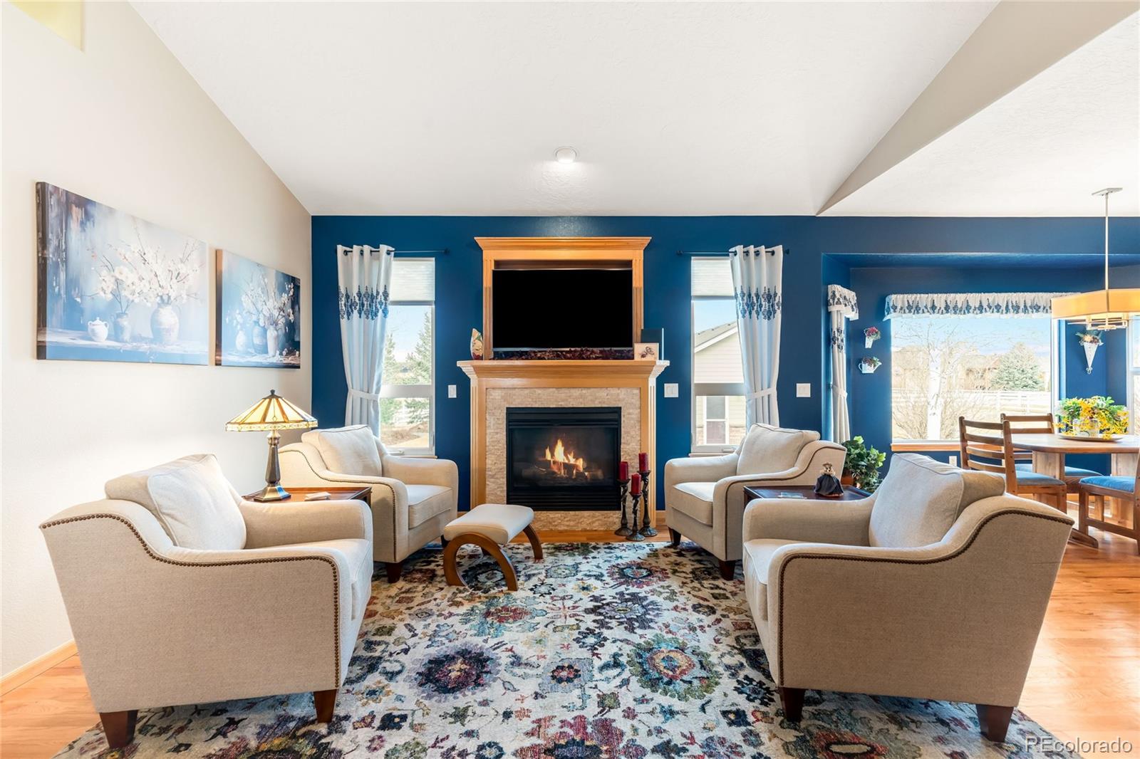 2013 Trail Ridge Drive Severance, CO 80615 - Photo 4 of 49 a living room with furniture a fireplace and a flat screen tv