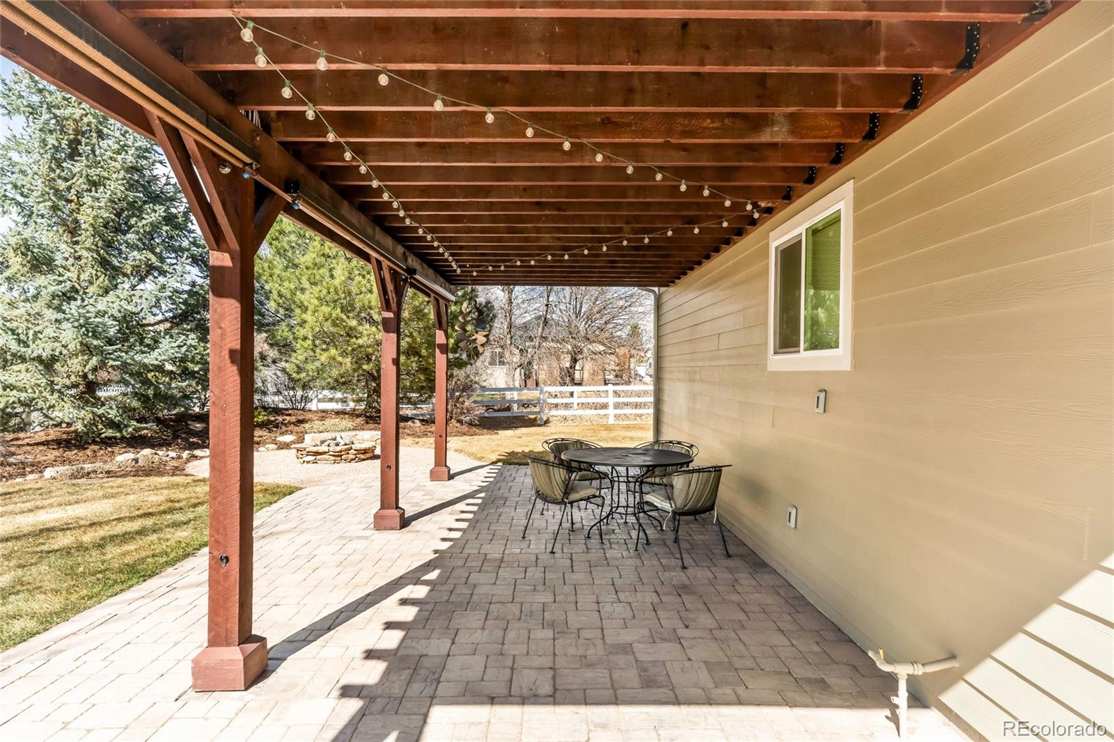 2013 Trail Ridge Drive Severance, CO 80615 - Photo 41 of 49 a view of a patio with table and chairs and wooden floor