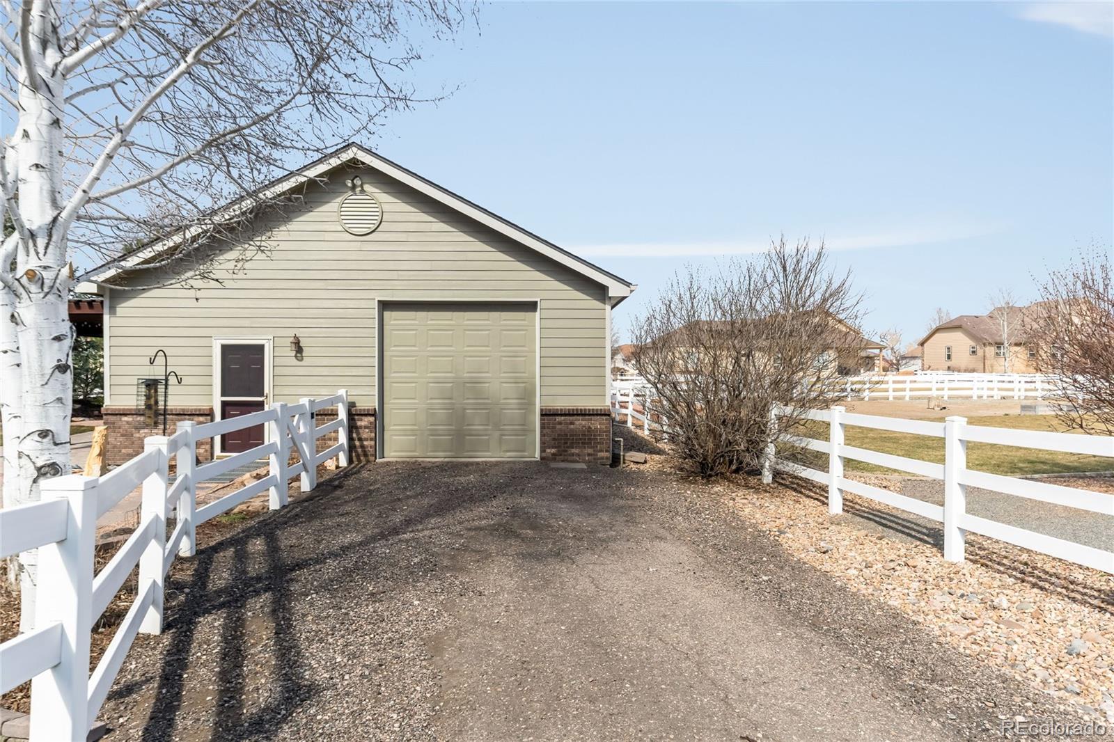 2013 Trail Ridge Drive Severance, CO 80615 - Photo 43 of 49 a view of a house with a yard and fence