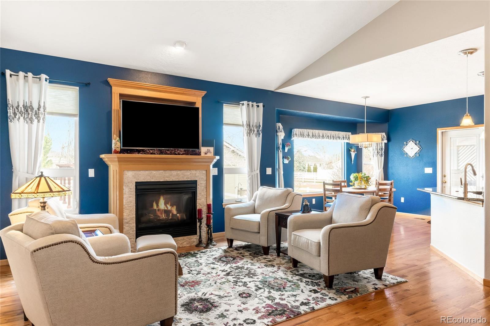 2013 Trail Ridge Drive Severance, CO 80615 - Photo 5 of 49 a living room with furniture a flat screen tv and a fireplace