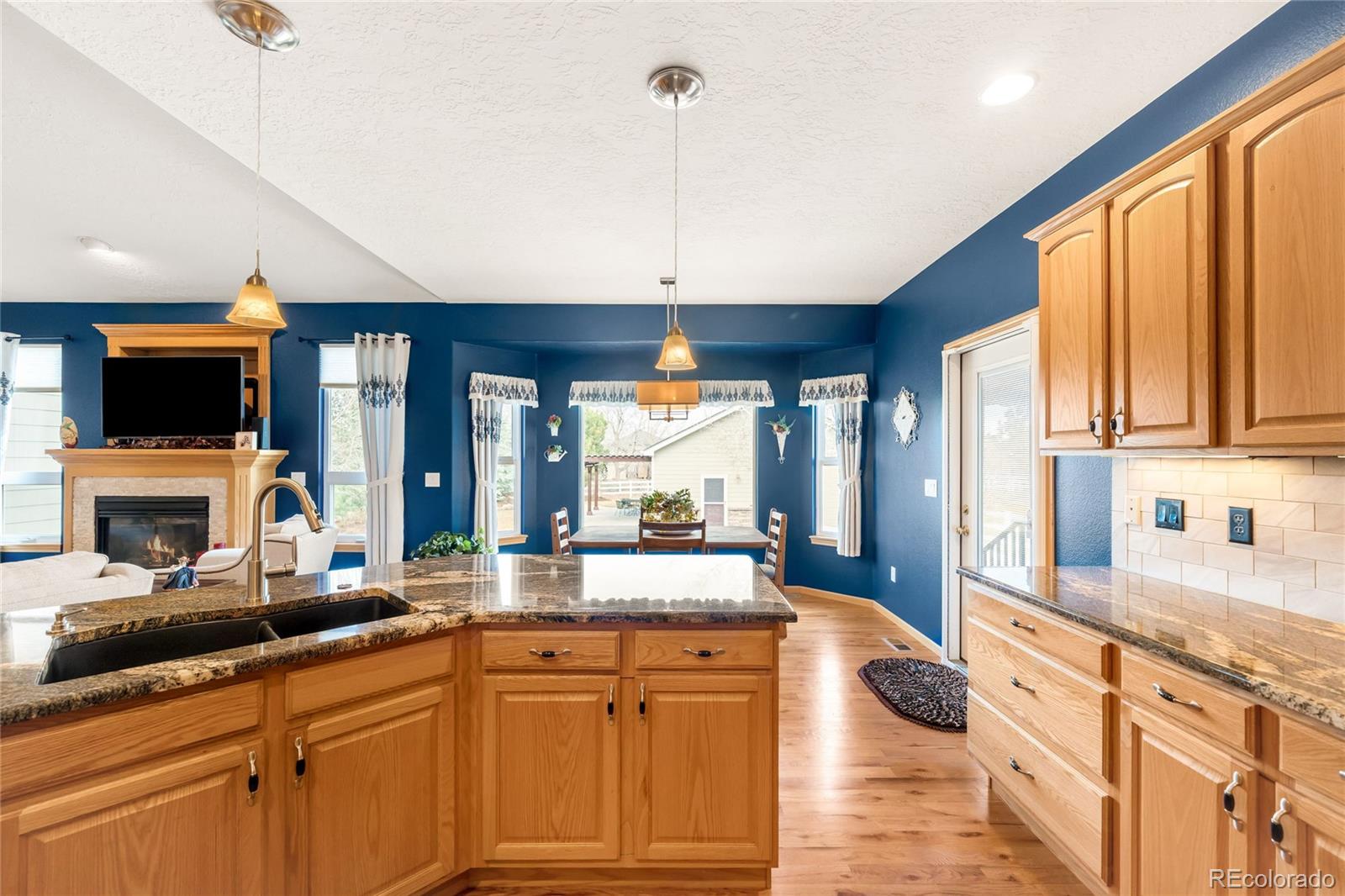 2013 Trail Ridge Drive Severance, CO 80615 - Photo 10 of 49 a large kitchen with stainless steel appliances granite countertop a stove a sink and a microwave oven