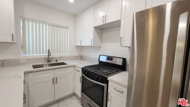 a kitchen with a sink stove and refrigerator
