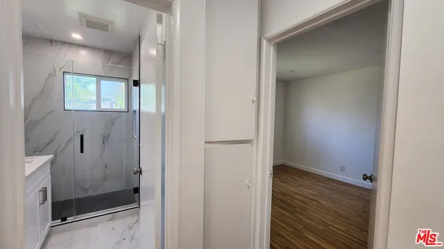 a view of a bathroom from a hallway