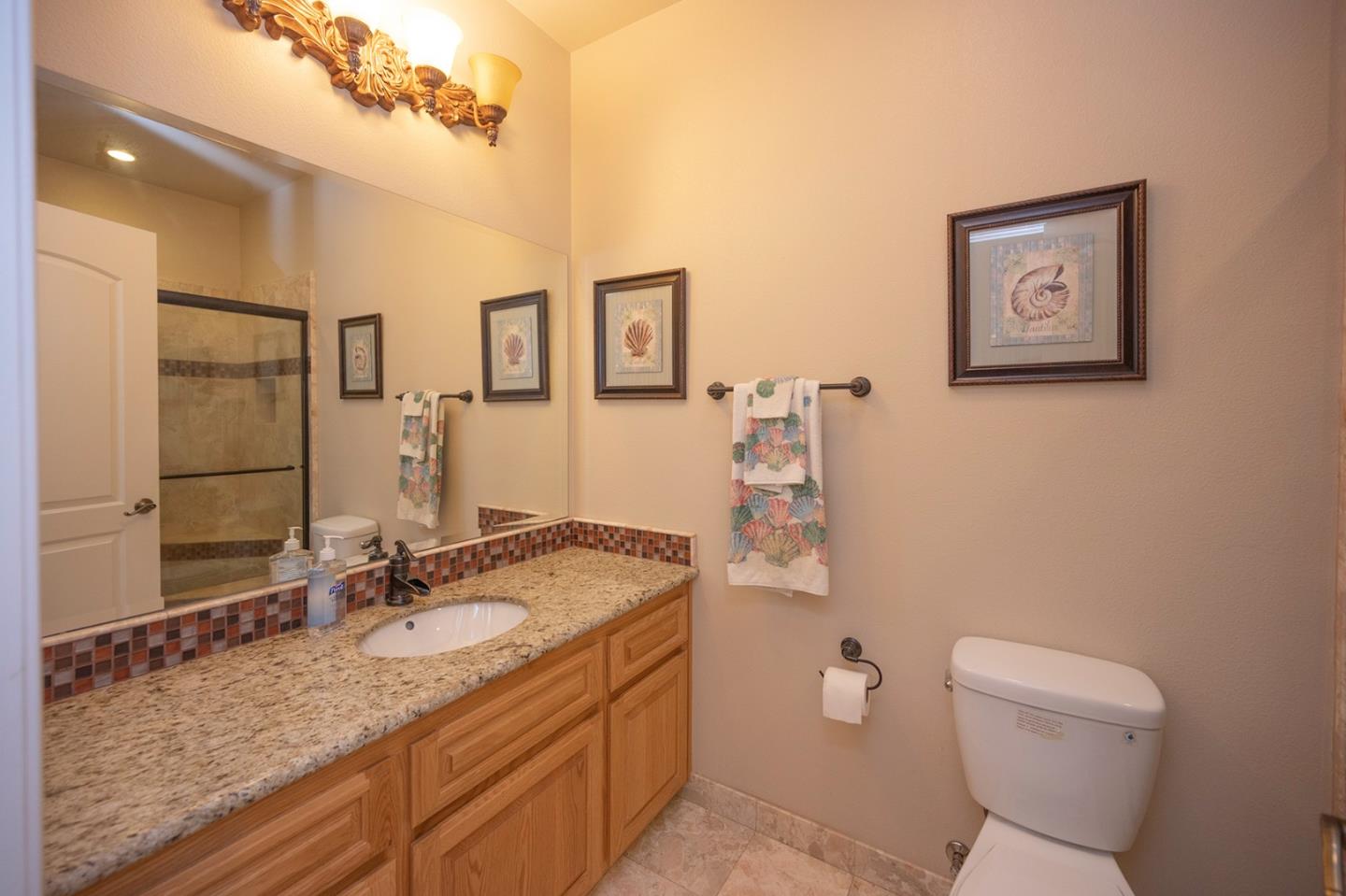 2271 Murphys Drive Arnold, CA 95223 - Photo 37 of 91 a bathroom with a granite countertop sink mirror vanity and toilet