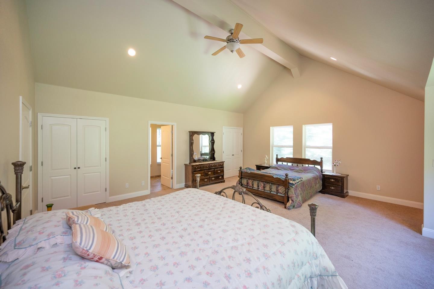 2271 Murphys Drive Arnold, CA 95223 - Photo 69 of 91 a spacious bedroom with a bed a couch and a chandelier