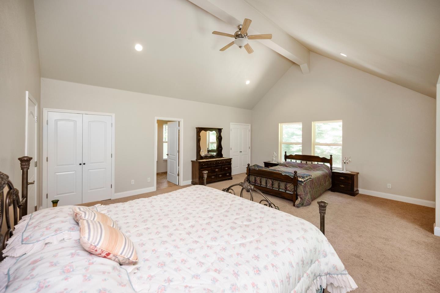 2271 Murphys Drive Arnold, CA 95223 - Photo 70 of 91 a spacious bedroom with a large bed and a chandelier