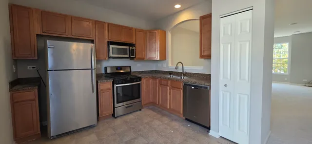 a kitchen with a refrigerator stove and sink