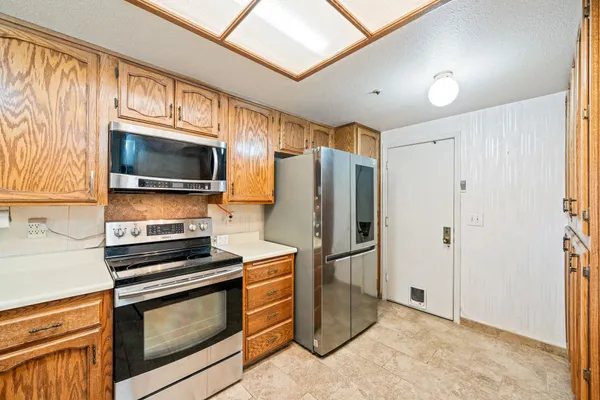 a kitchen with granite countertop a stove top oven sink and cabinets