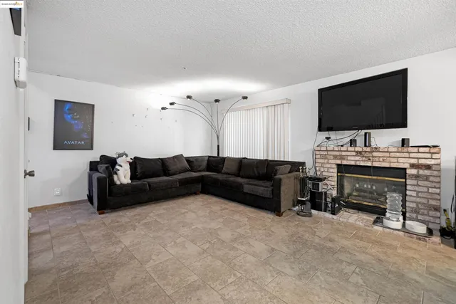 a view of kitchen with kitchen island microwave and refrigerator