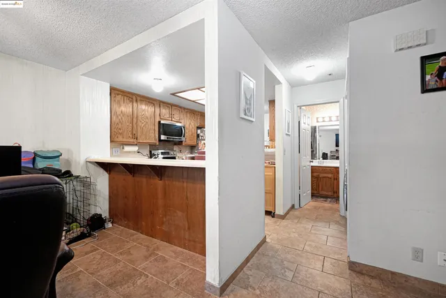 a kitchen with stainless steel appliances a stove refrigerator sink and microwave