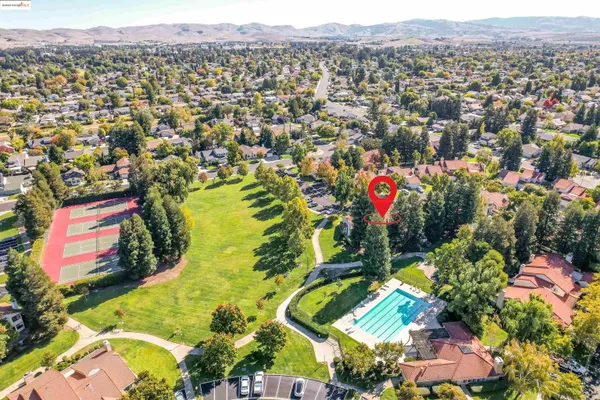 an aerial view of residential houses with outdoor space and swimming pool