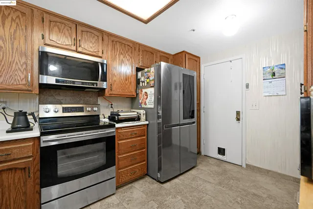 a kitchen with kitchen island granite countertop a sink and a stove