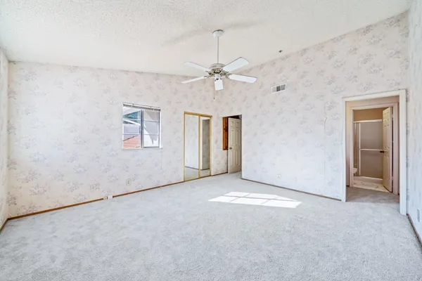 a view of walk in closet with clothes