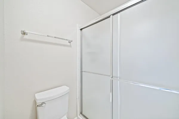 a view of a balcony with wooden floor and fence