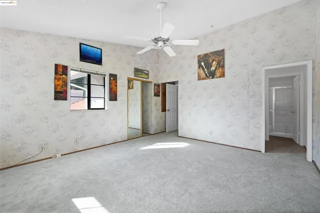 a view of a room with wooden floor and furniture