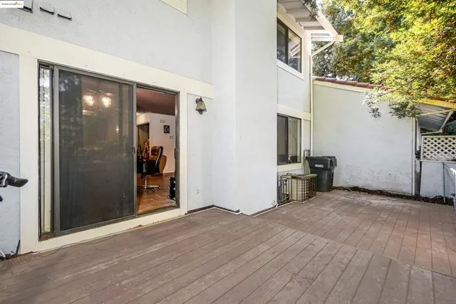 an aerial view of residential houses with outdoor space and trees