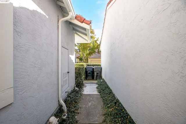 a view of staircase with lots of frames on wall and wooden floor