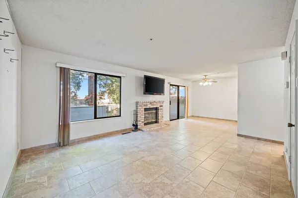 a living room with a fireplace and a flat screen tv