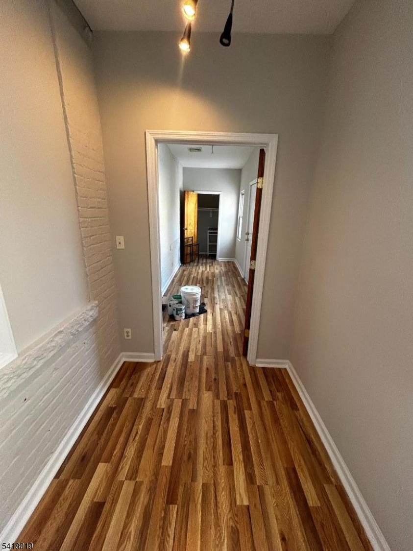 26 Ferry Street Newark, NJ 07105 - Photo 11 of 16 a view of a room with wooden floor and staircase
