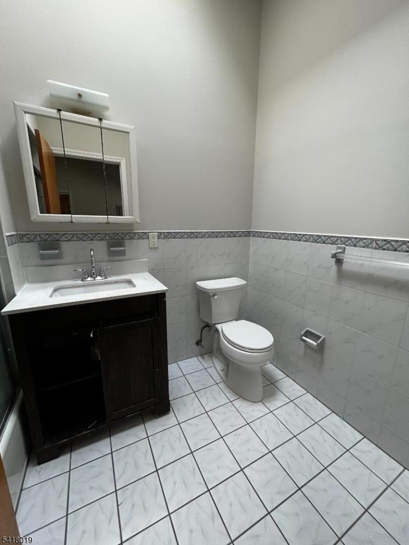26 Ferry Street Newark, NJ 07105 - Photo 15 of 16 a bathroom with a toilet sink and mirror