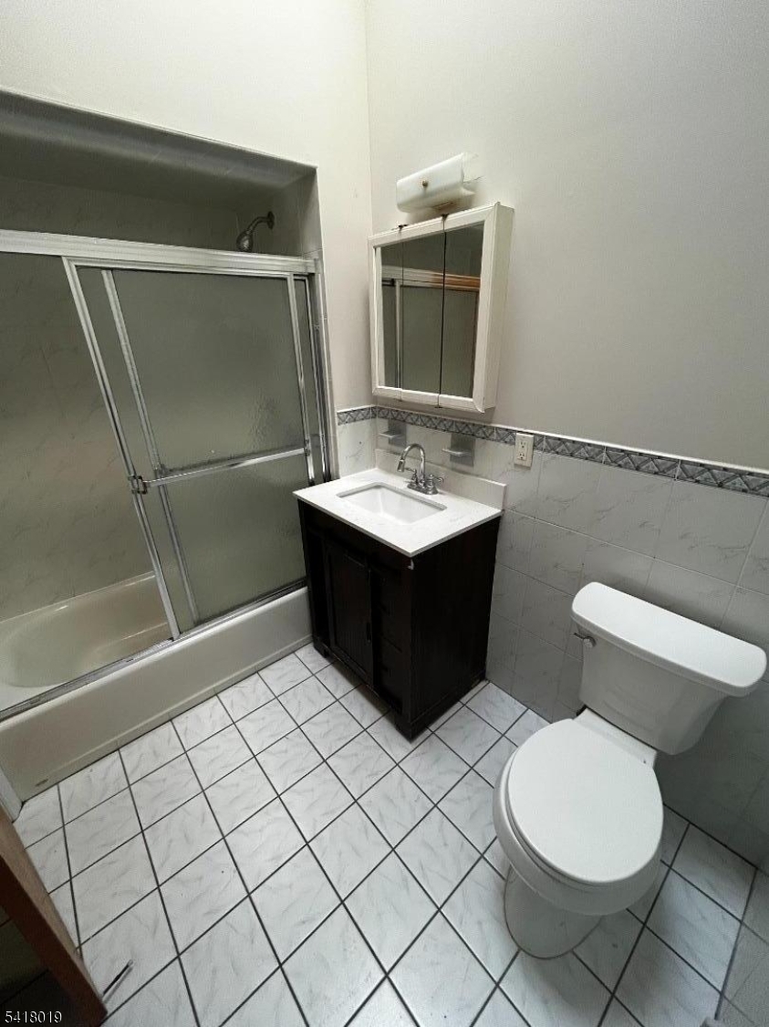 26 Ferry Street Newark, NJ 07105 - Photo 16 of 16 a bathroom with a sink toilet and mirror