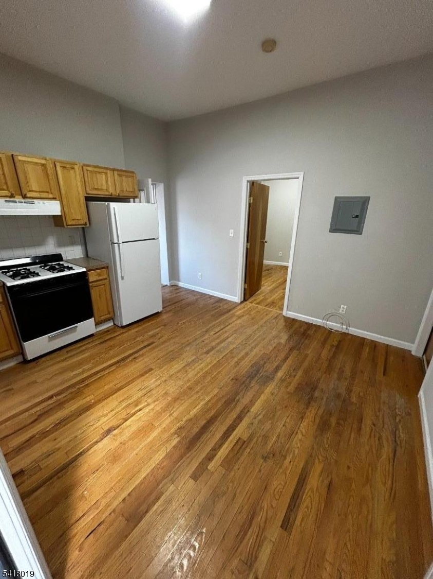 26 Ferry Street Newark, NJ 07105 - Photo 4 of 16 a view of a kitchen with wooden floor