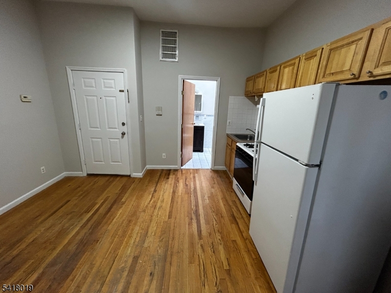 26 Ferry Street Newark, NJ 07105 - Photo 7 of 16 a view of a kitchen from a hallway