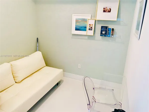 a bedroom with a bed and a chair