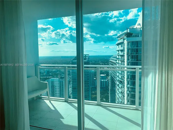 a view of a glass door and a yard