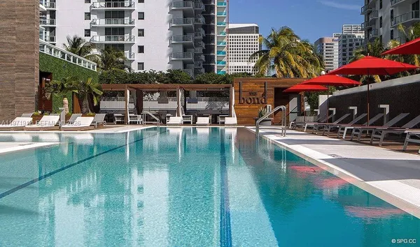 a swimming pool view with a outdoor seating