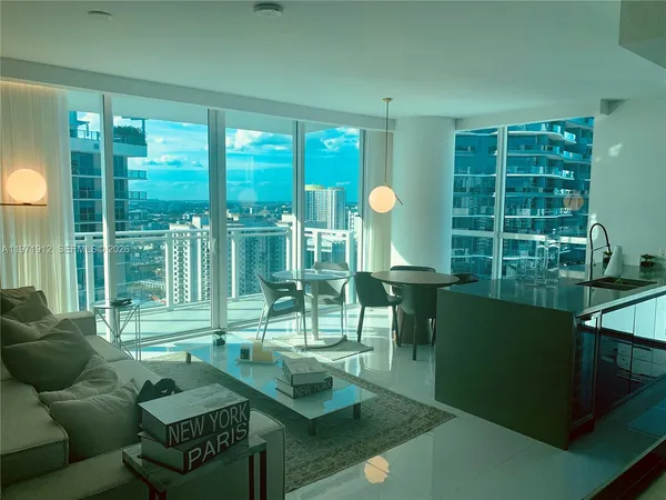 a living room filled with furniture and a large window