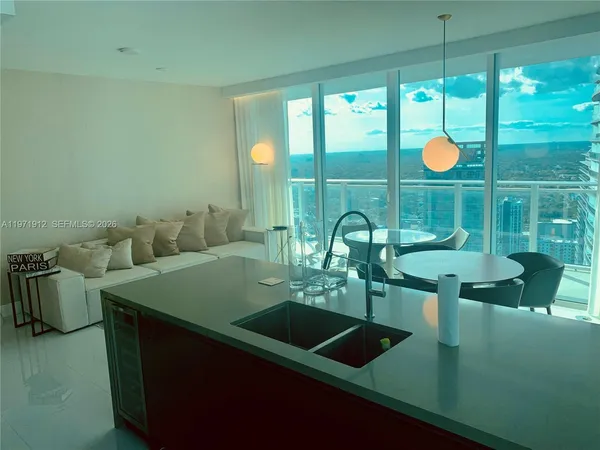 a kitchen with a sink and large window