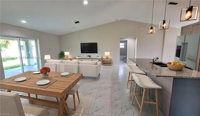 a kitchen with a table chairs stove and refrigerator