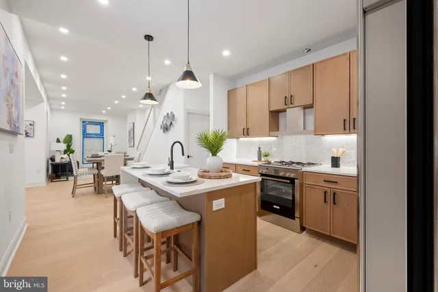 a kitchen with stainless steel appliances granite countertop counter space a sink cabinets and wooden floor