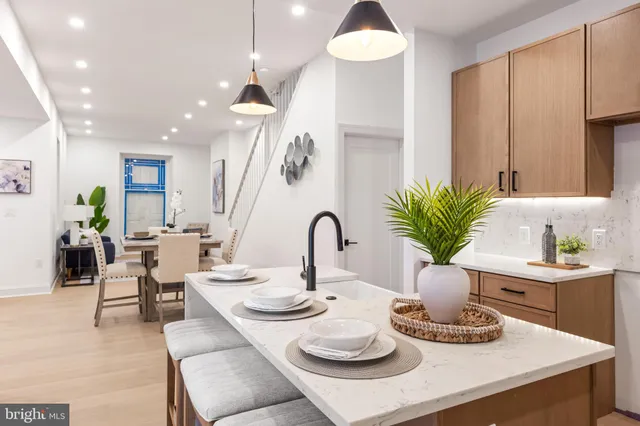 a view of a dining room with furniture and a potted plant