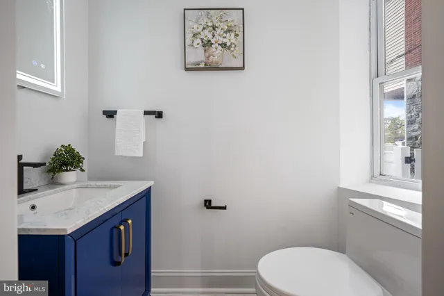 a bathroom with a sink vanity and toilet