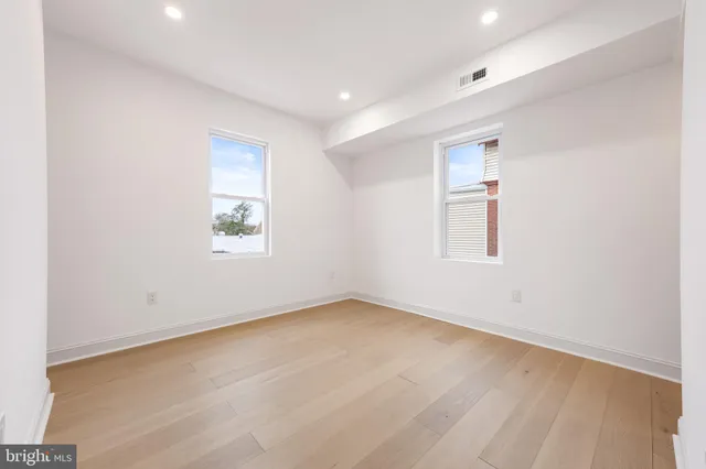 an empty room with a empty space and windows