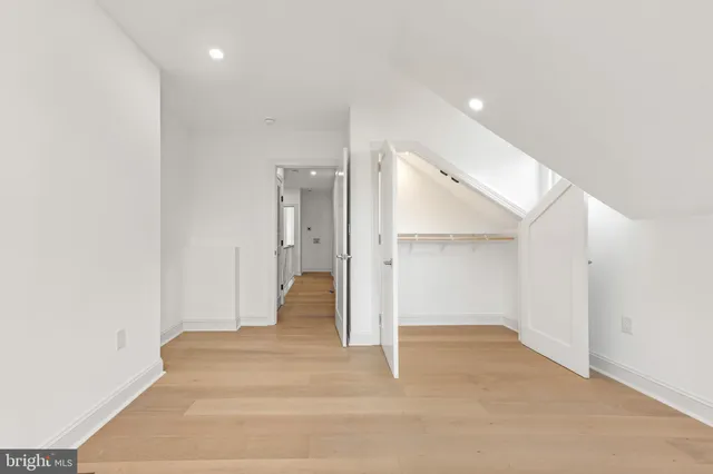 a bedroom with a large bed and a potted plant