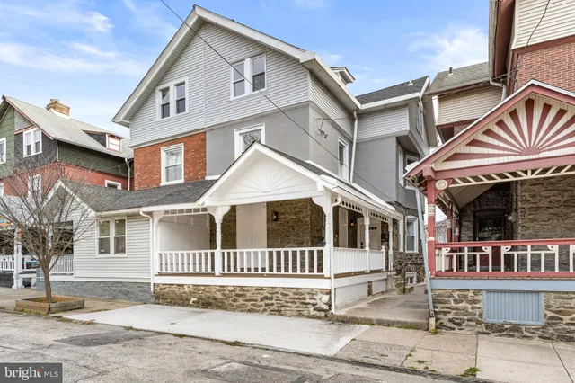 a view of a house with wooden fence