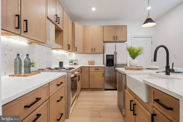 a kitchen with a sink cabinets and appliances