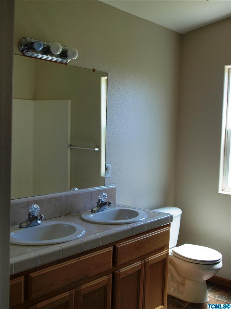 166 South Filbert Road Exeter, CA 93221 - Photo 10 of 15 a bathroom with a sink and a toilet