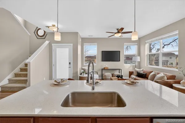 a kitchen with a sink a counter top space and a chandelier