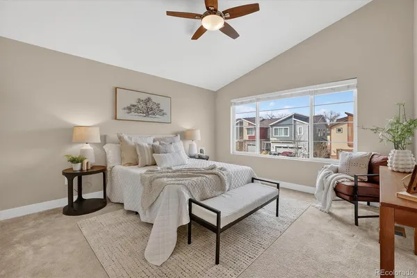 a spacious bedroom with a bed and a large window