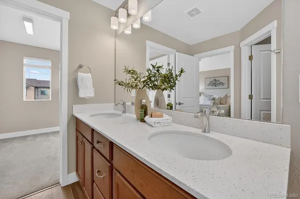 a bathroom with a granite countertop sink a large mirror and vanity