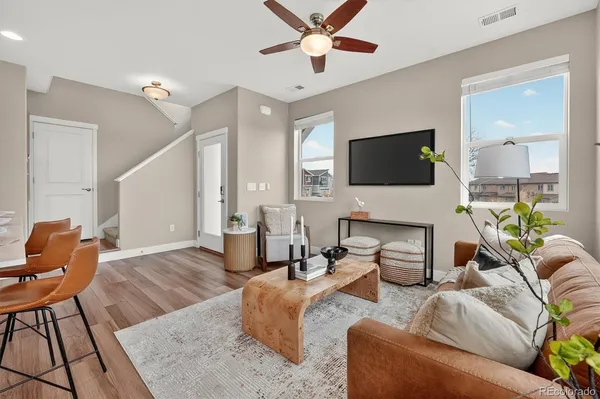 a living room with furniture a flat screen tv and a fireplace