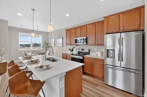 a kitchen with refrigerator cabinets and wooden floor