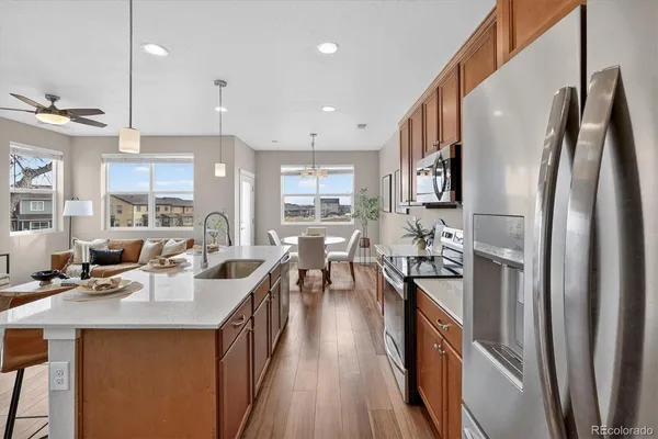 a kitchen with stainless steel appliances a sink stove and refrigerator