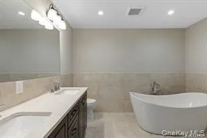 a bathroom with a bathtub and a sink