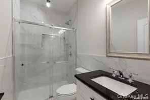 a bathroom with a sink toilet a mirror and shower